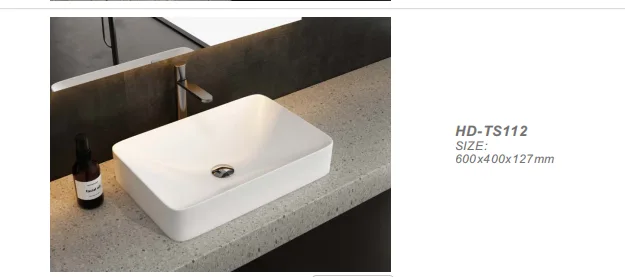 High-angle view of a non-porous rectangular solid surface sink mounted on an industrial terrazzo countertop.
