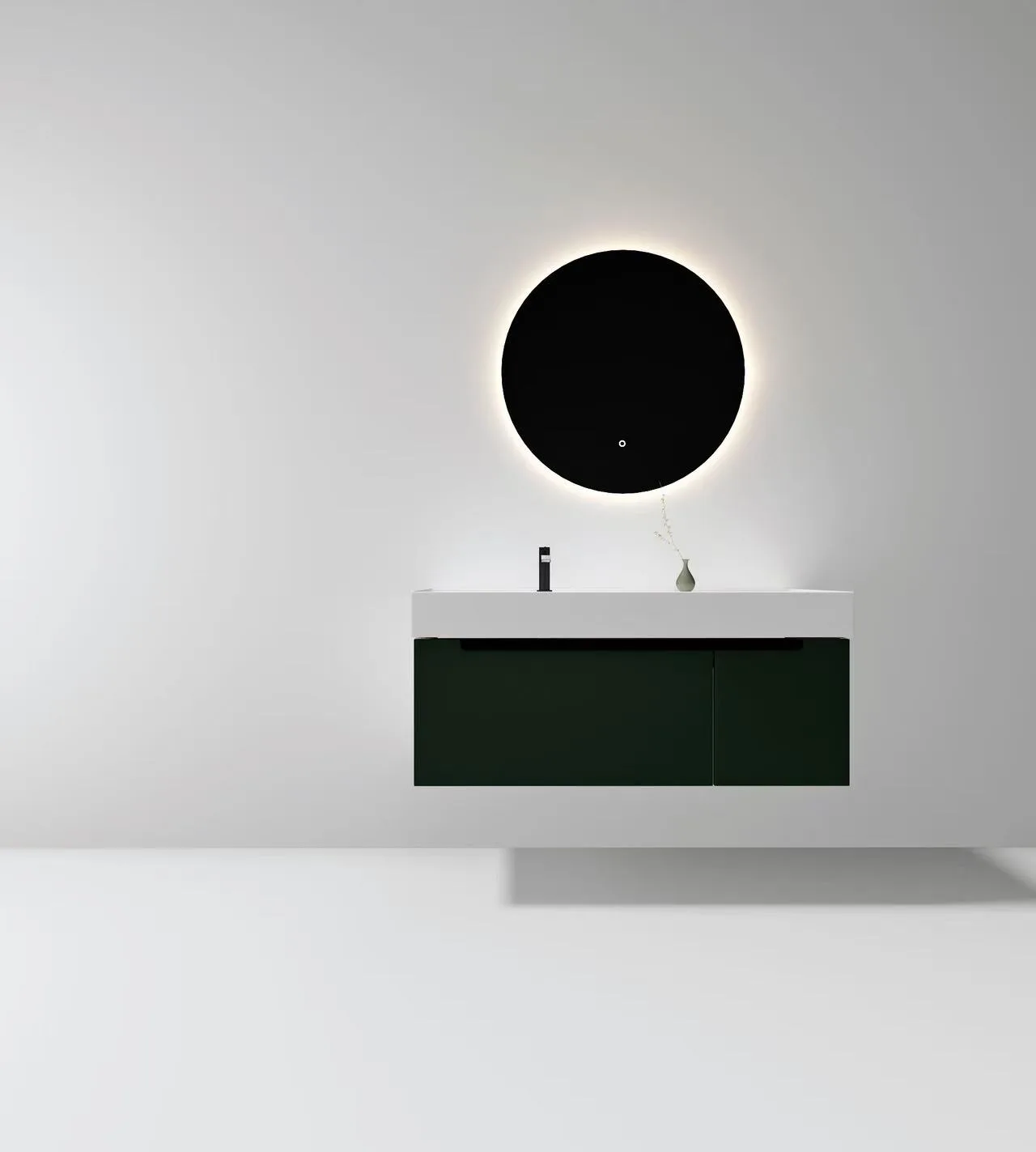 Commercial solid surface vanity basin mounted flawlessly on a dark green floating vanity cabinet under an LED mirror.