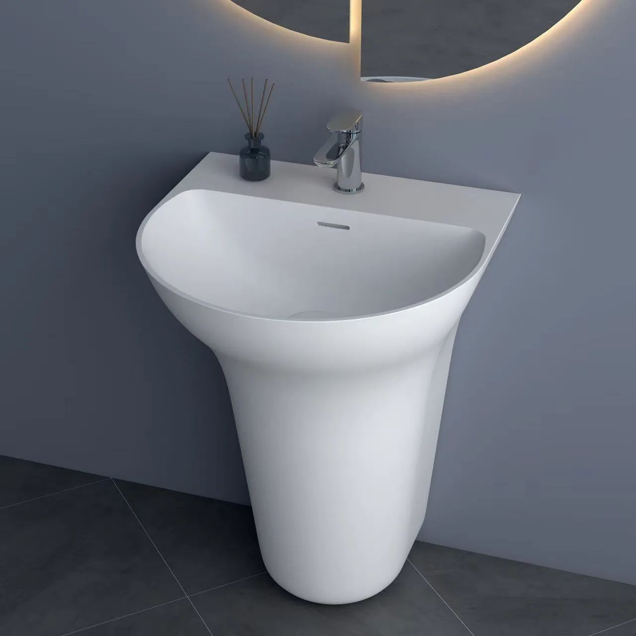 Close-up of a matte white freestanding solid surface sink showcasing the integrated faucet deck and deep basin profile.