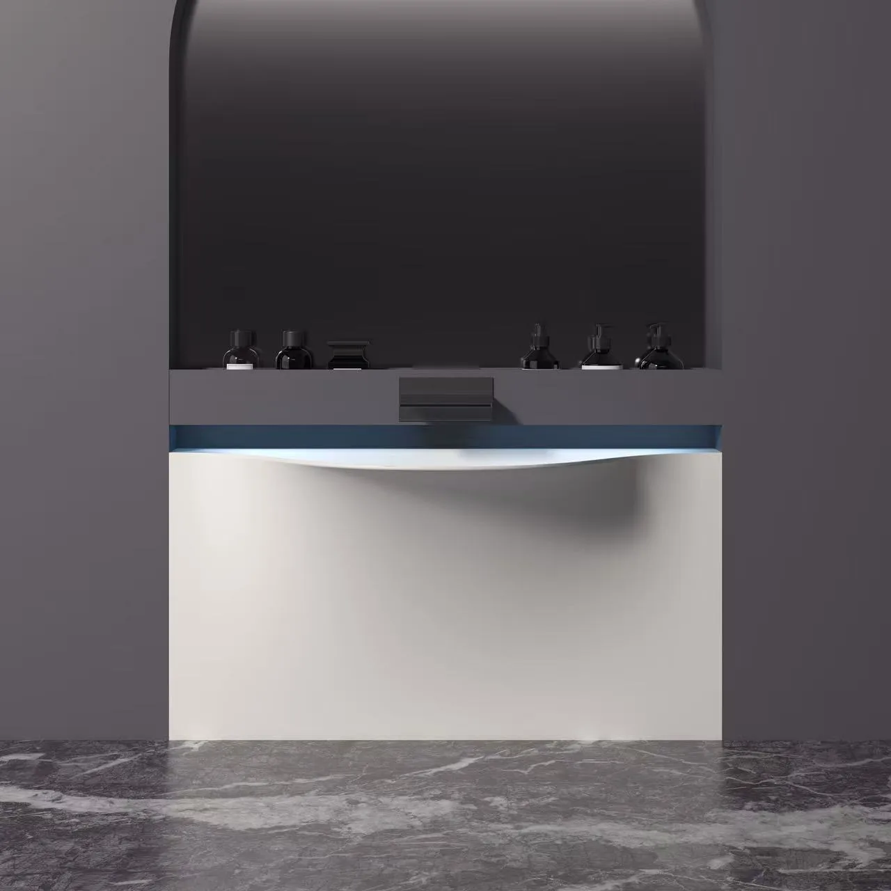 Front view of a monolithic sculptural solid surface sink paired with a wall-mounted matte black waterfall faucet in a modern hospitality setting.