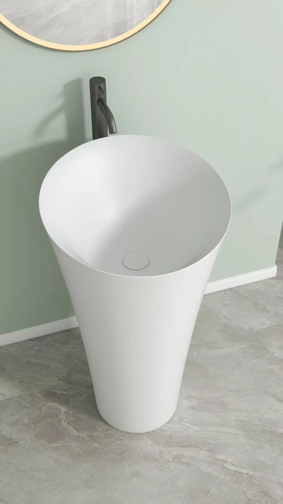 Matte white round pedestal sink installed next to a shower enclosure, maximizing floor space in a compact luxury bathroom.