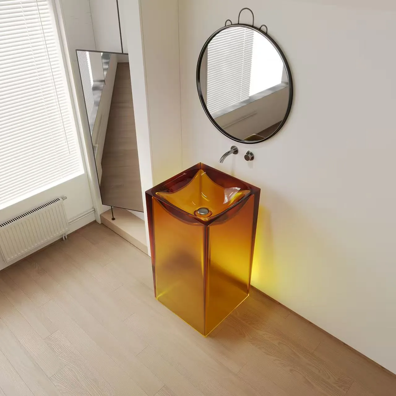 High-gloss amber square resin pedestal sink providing a striking sculptural focal point in a high-end commercial restroom.