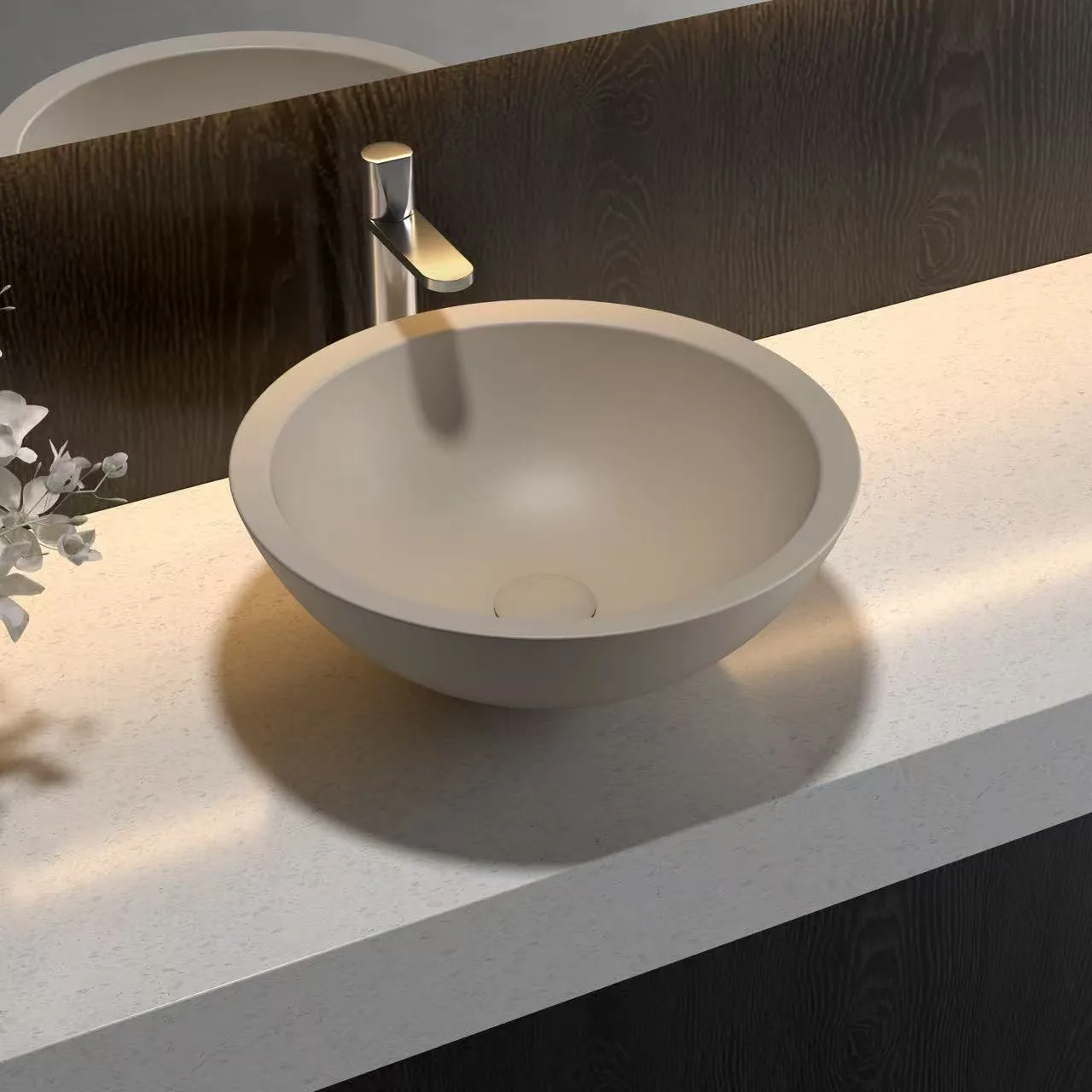 Warm taupe colored Round Solid Surface Vessel Sink installed on a commercial countertop for a minimalist luxury visual.