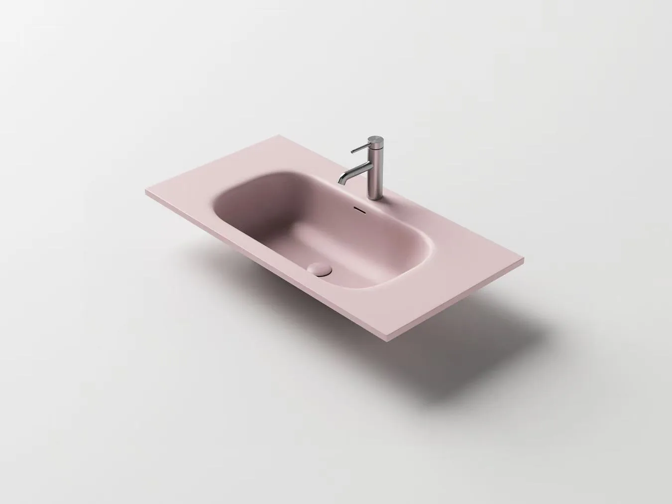 Custom blush pink solid surface washbasin engineered for hospitality projects requiring distinct interior aesthetics.