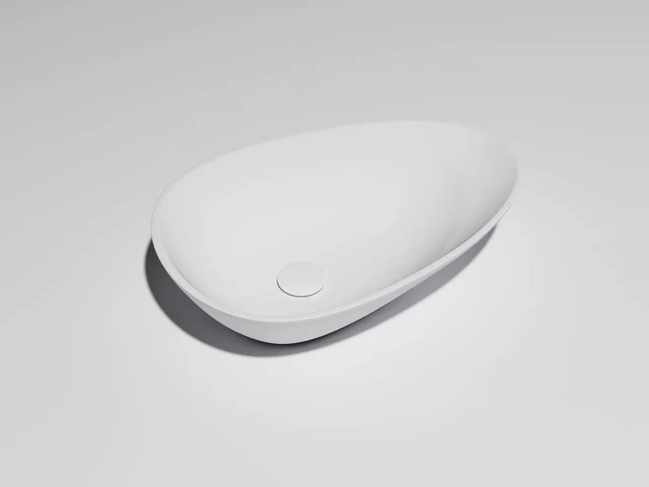 Architectural 1-piece solid surface countertop basin featuring a seamless teardrop shape and matte white finish.