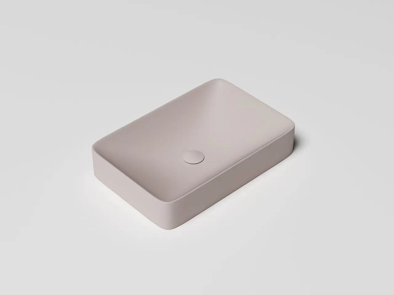 atte white rectangular solid surface sink resting seamlessly on a dark commercial vanity cabinet alongside luxury hotel amenities.