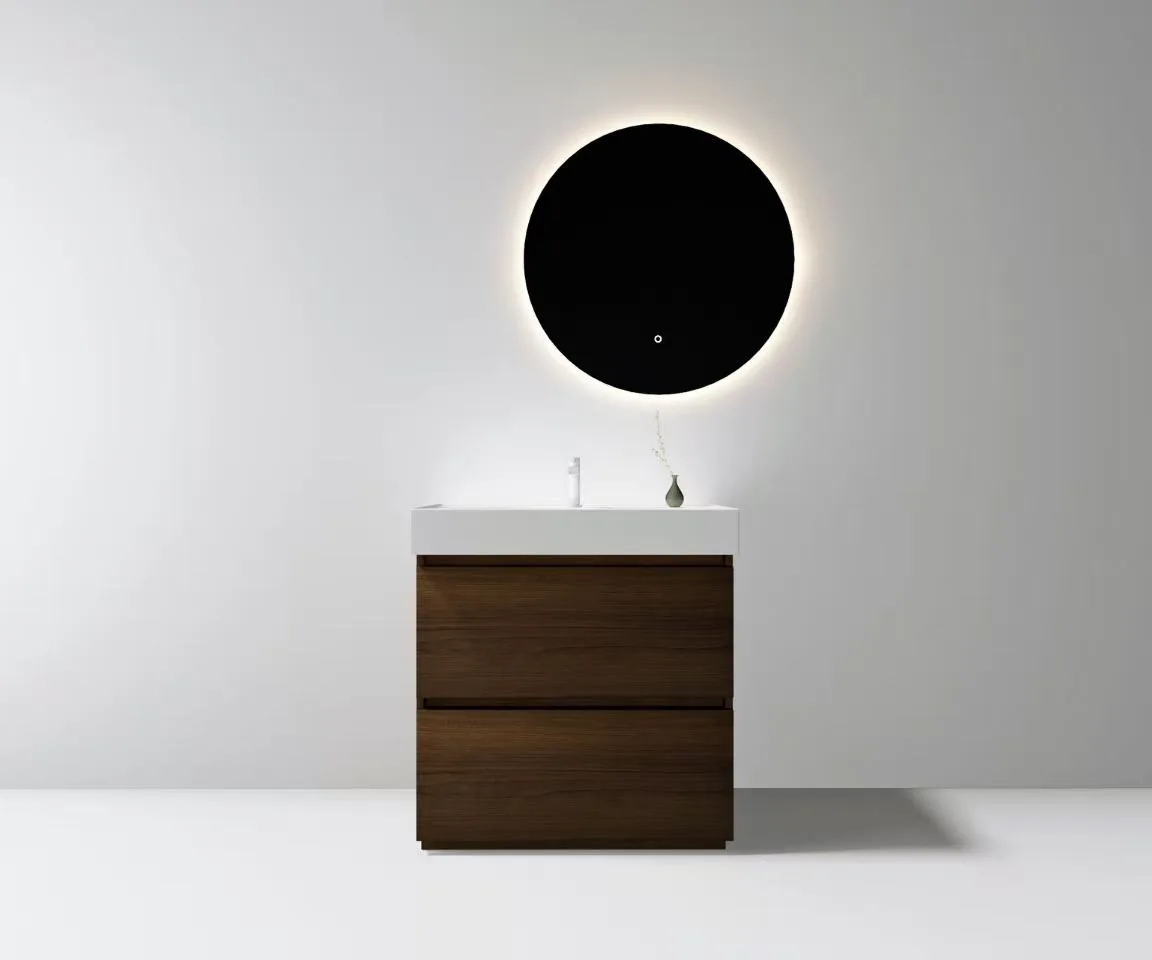 Minimalist white solid surface vanity basin capping a two-drawer wood veneer vanity cabinet in a hotel suite.
