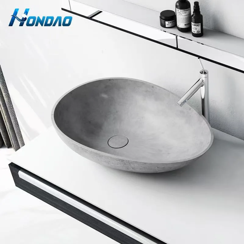 Concrete grey solid surface countertop basin installed on a modern vanity cabinet with black metal accents.