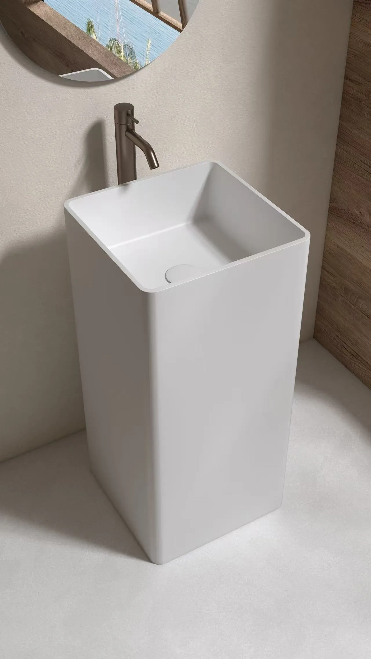 Commercial-grade square pedestal sink featuring a monolithic solid surface structure for high-traffic hospitality environments.