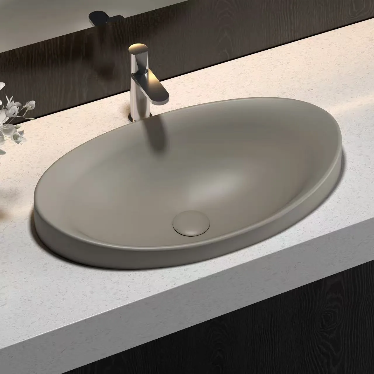 Commercial-grade white oval solid surface sink engineered for high impact resistance and minimalist hospitality design.