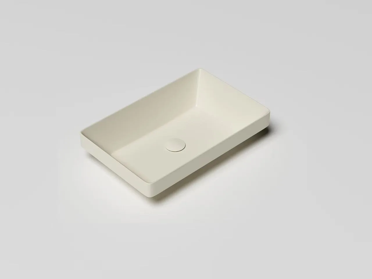 Top-down view of a matte white solid surface thin-edge vessel sink highlighting its minimalist ultra-slim rim.