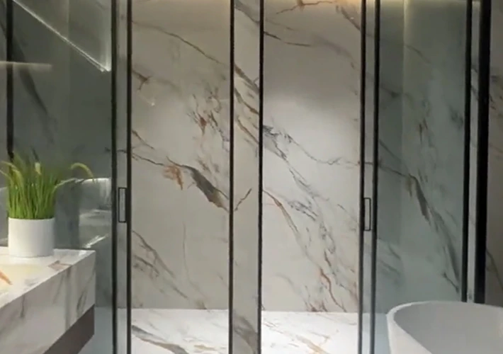Cultured marble shower panels seamlessly matching a commercial vanity in a luxury hotel bathroom.
