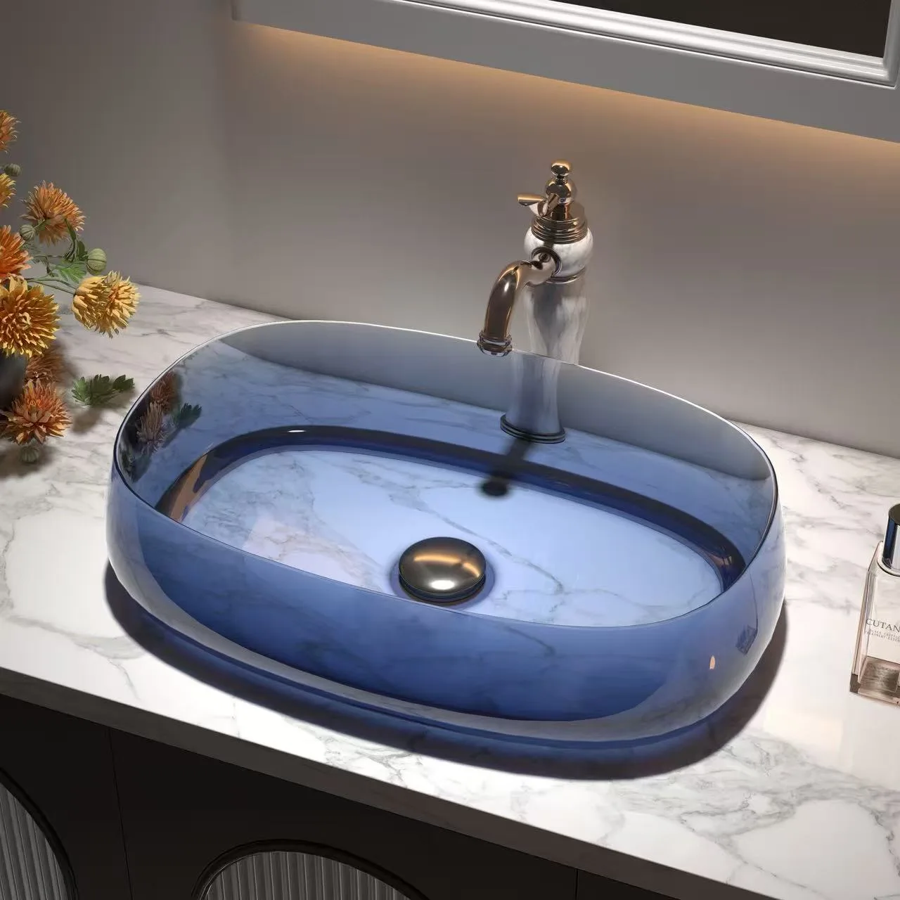 Elegant master washroom displaying an ocean blue translucent marble glass vessel sink styled on a polished Carrara countertop.