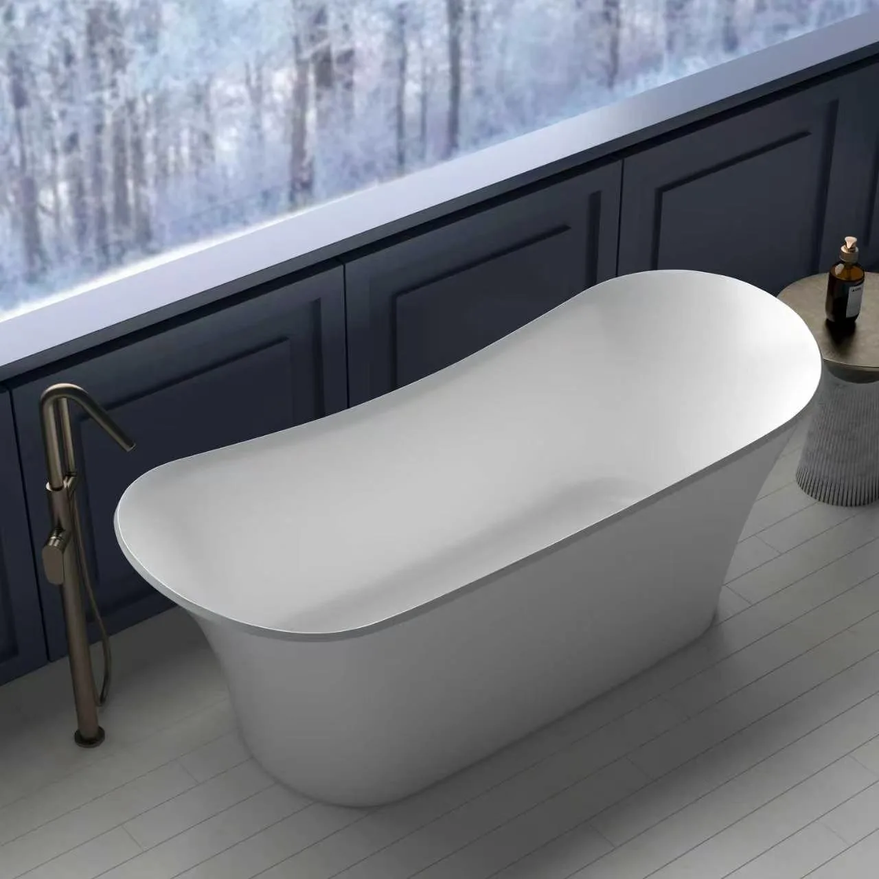 High-angle perspective view of the Matte White Double Slipper Solid Surface Bathtub set against a window overlooking a winter landscape, paired with a floor-mounted brushed bronze tub filler.