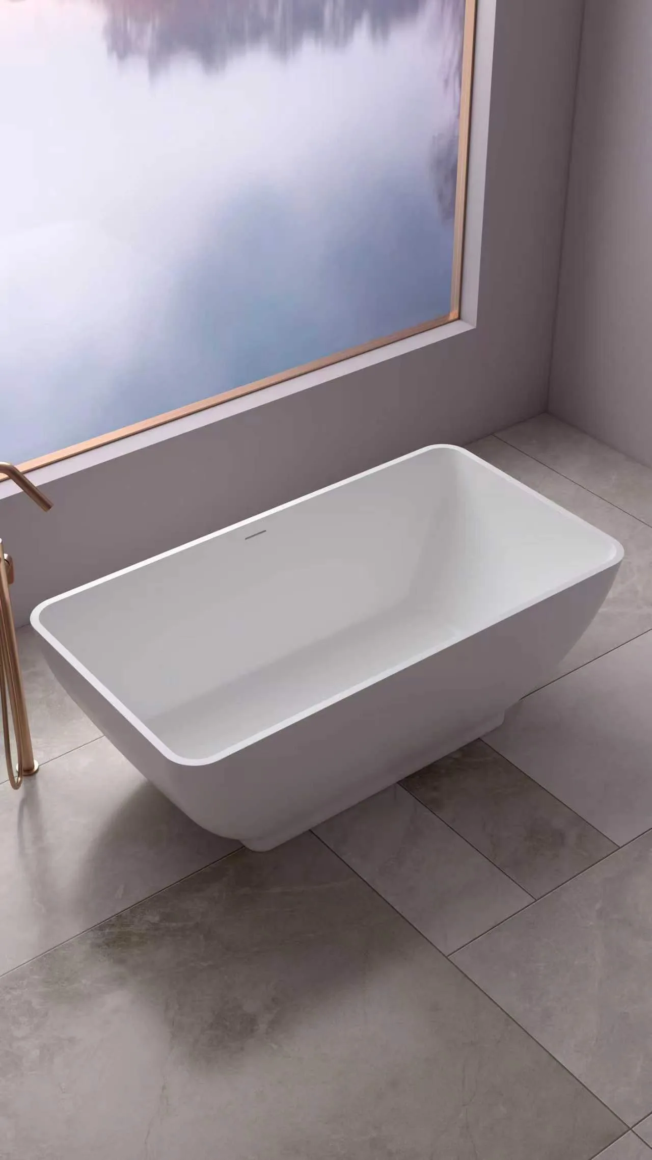 Three-quarter high-angle perspective view of the matte white tapered solid surface freestanding bathtub showcasing its outward sloping walls and modern minimalist placement by a window deck.