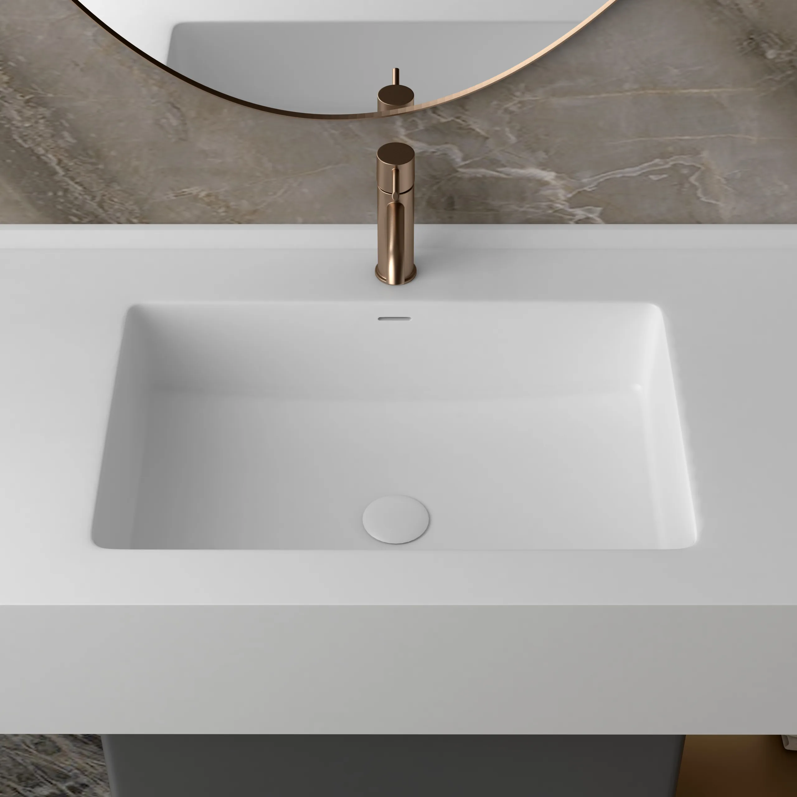 Close-up top-down view of the seamless matte white rectangular sink on the solid surface integrated basin bathroom vanity console deck.