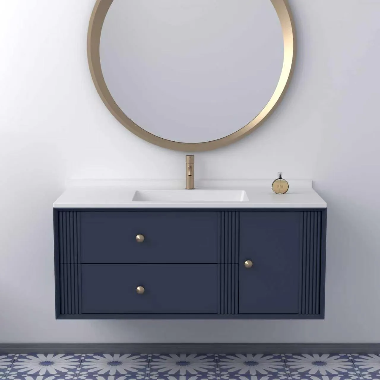 Front elevation view of a navy blue floating bathroom vanity featuring decorative fluted vertical accents, brushed gold hardware knobs, and an integrated matte white solid surface sink basin.