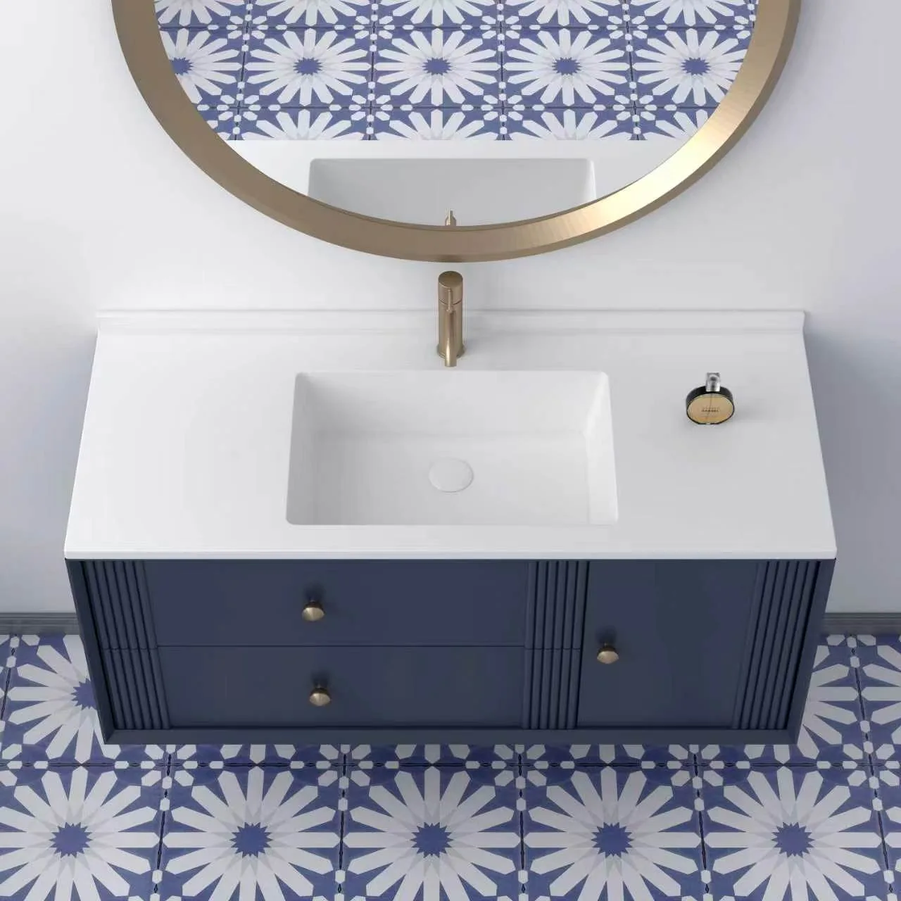 Direct top-down view showcasing the clean geometric lines of the integrated solid surface sink basin, centered basin drain, and asymmetric layout over the navy blue drawer and cabinet configuration.