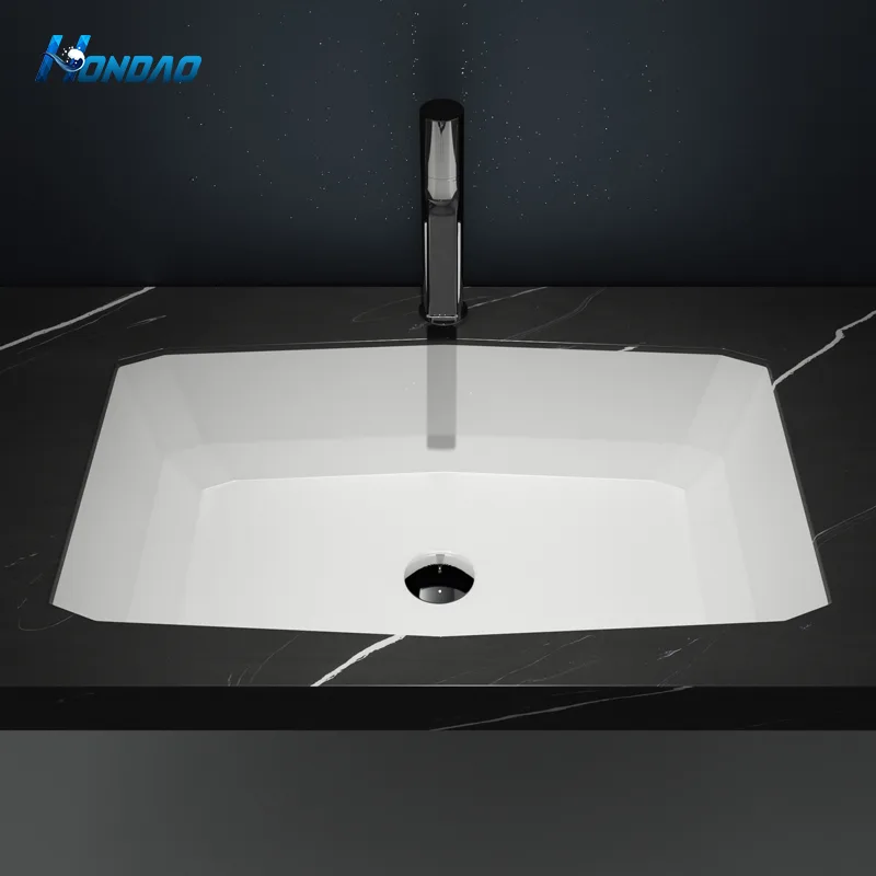 Matte White Solid Surface Chamfered Undermount Basin installed in a black marble countertop with a tall modern faucet.